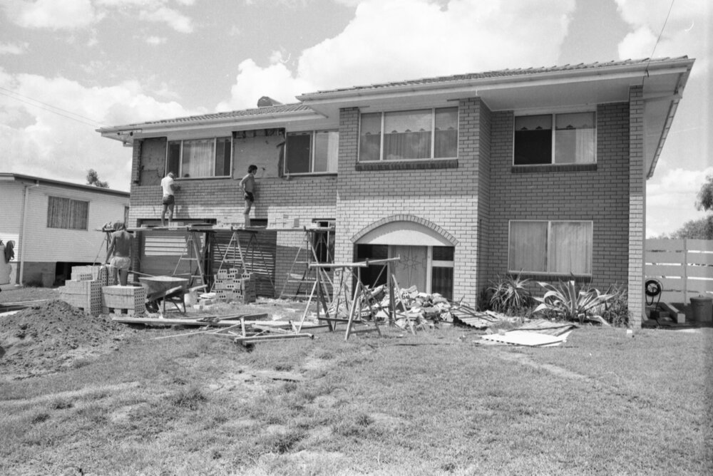 Builders working on a two-storey 1970s home sold by Action Realty, Ipswich, February 1978