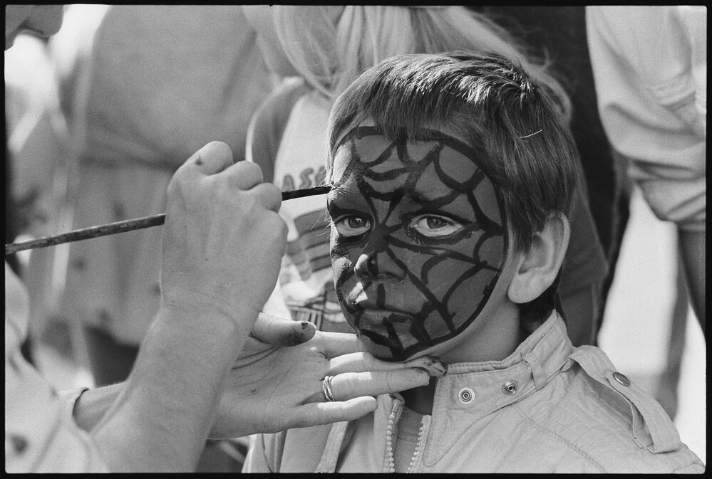 Unidentified young boy having his face painted, Ipswich, July 1985