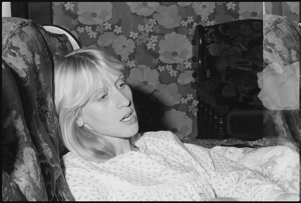 Unidentified woman leaning on couch, Ipswich, July 1985