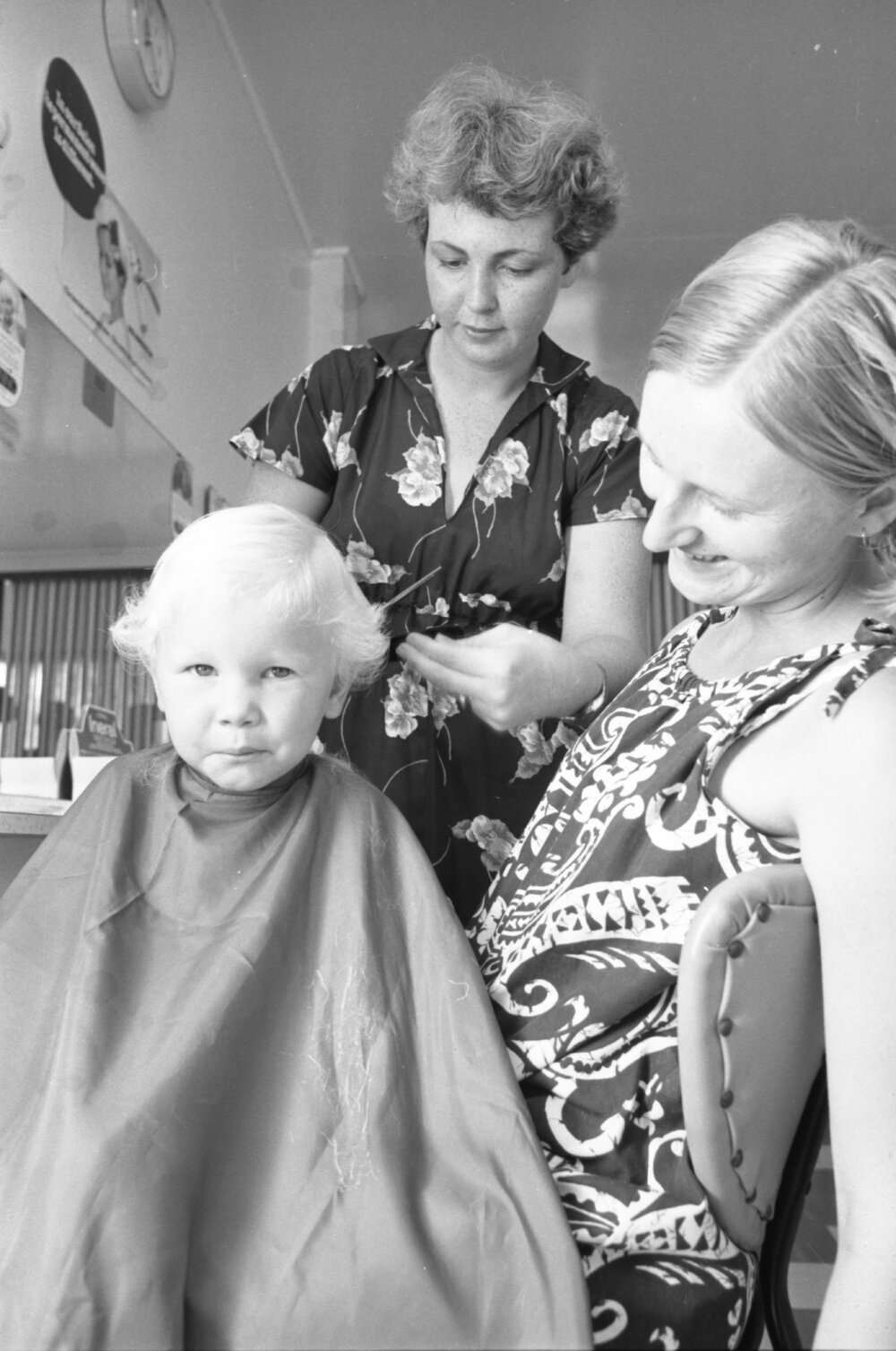 Little boy having his first hair cut Clarkia Salon, Ipswich, February 1978