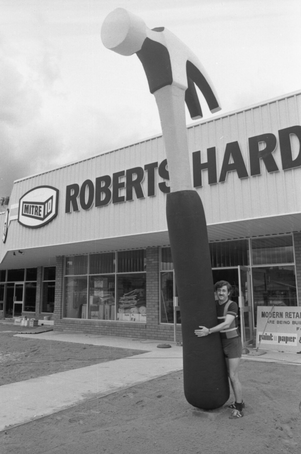 Thought to be John Roberts with Giant Hammer outside Roberts Hardware Store, Bundamba, Ipswich, March 1978