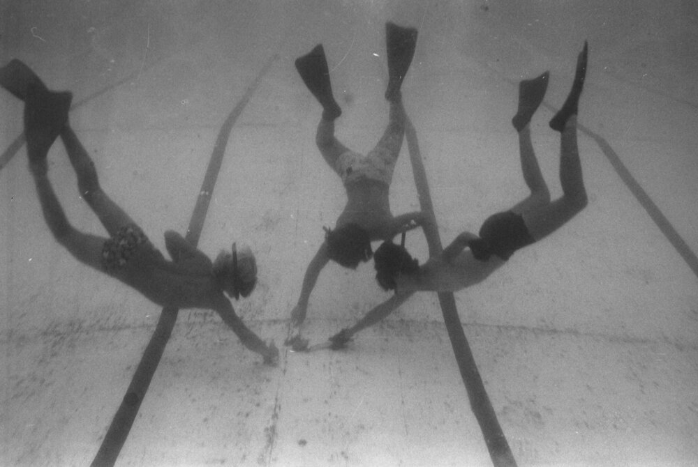 Unidentified children diving with snorkels, masks and fins to play underwater hockey, Brassall, March 1978