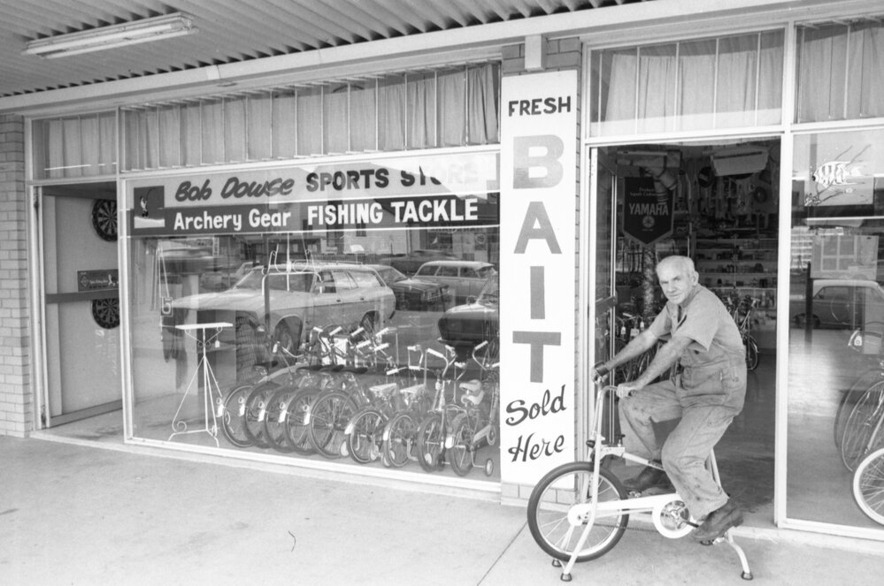 Thought to be Bob Dowse in front of Bob Dowse Sports Store, North Ipswich, March 1978