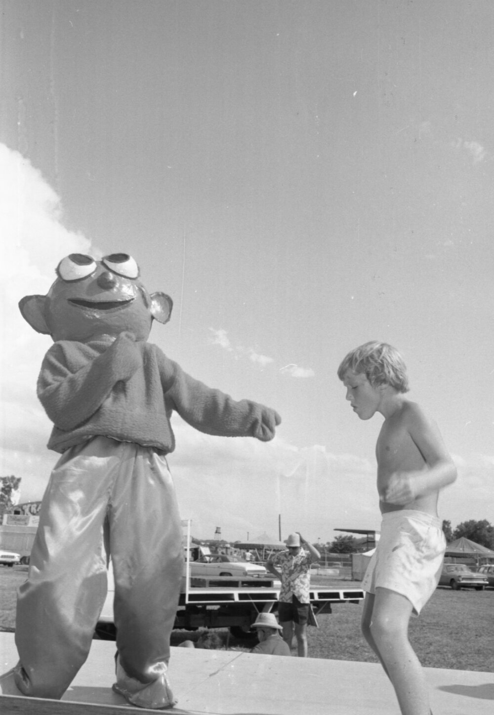 Boy dancing on stage with mascot at Lions Carnival, Ipswich, December 1979