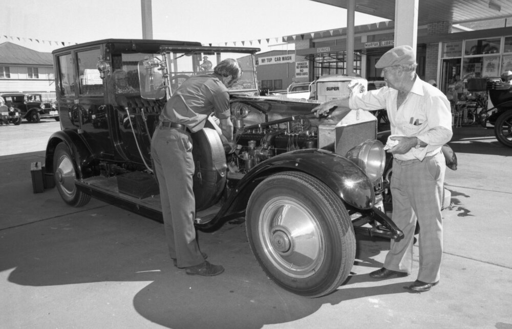 Two men refueling a vintage car at the North Side Star Service Station, North Ipswich, Ipswich, April 1978