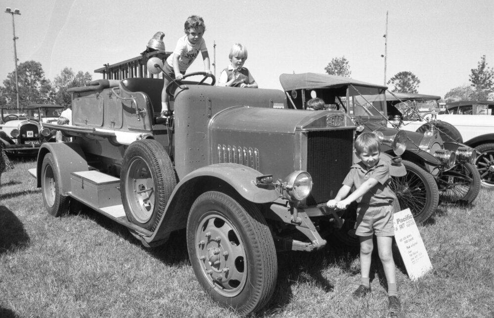 Three boys play on a 1923 Dennis Fire Engine at the 1978 Australian International Veteran and Vintage Motor Rally at the Ipswich Showgrounds, Ipswich, April 1978