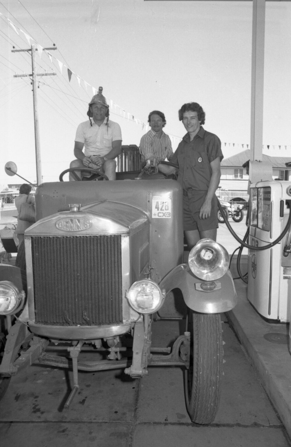 Three men refueling a 1923 Dennis Fire Engine at the North Side Star Service Station, North Ipswich, Ipswich, April 1978