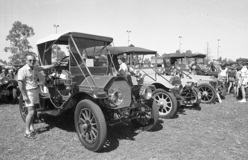 Man with 1911 Mitchell Roadster at the 1978 Australian International Veteran and Vintage Motor Rally at the Ipswich Showgrounds, Ipswich, April 1978