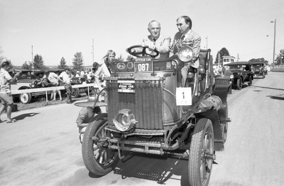 Mayor Arthur George Hastings and Llew Edwards with Gardner-Serpollet steam-powered car at the 1978 Australian International Veteran and Vintage Motor Rally at the Ipswich Showgrounds, Ipswich, April 1978