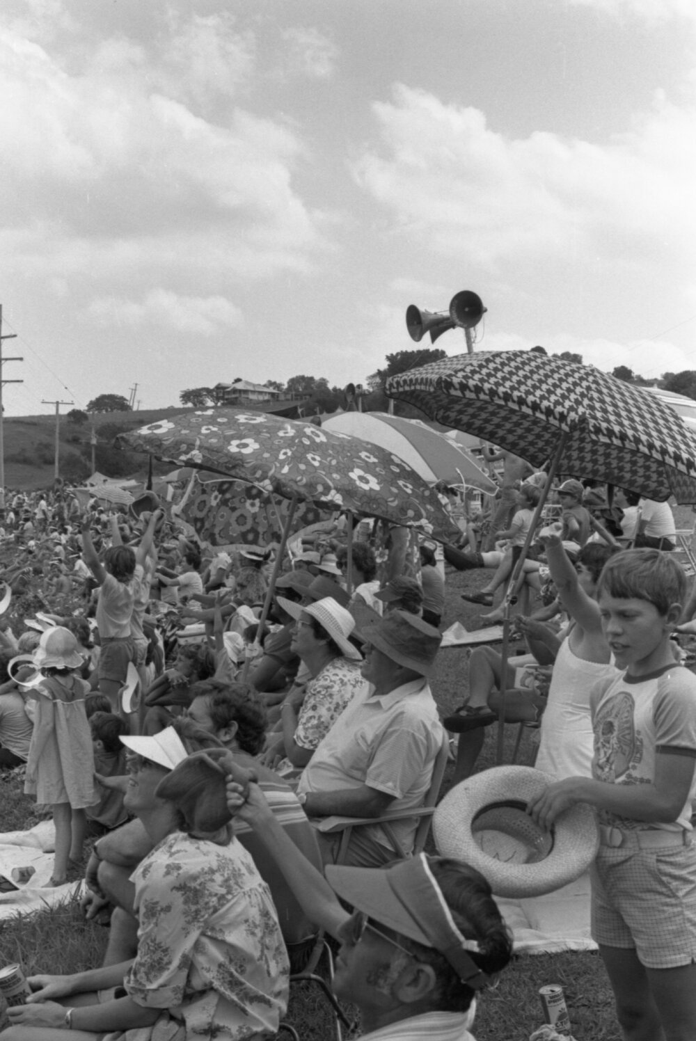 Racegoers on top of a hill watch an aerobatics show at the 1979 Queensland Times Off-Road Spectacular, Minden, Somerset, November 1979