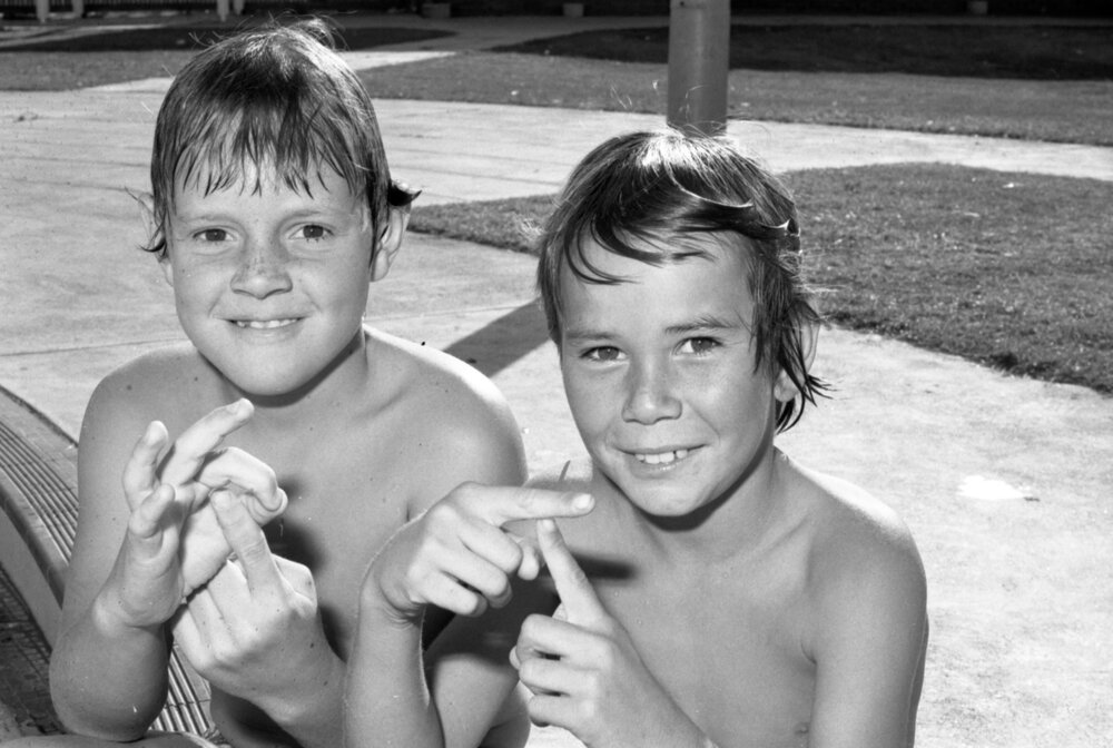 Boys signing 'QT' at the Bundamba pool, Bundamba, October 1977