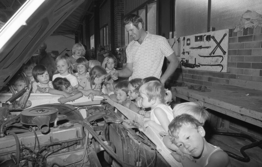 Man teaching children about cars, Ipswich, October 1977