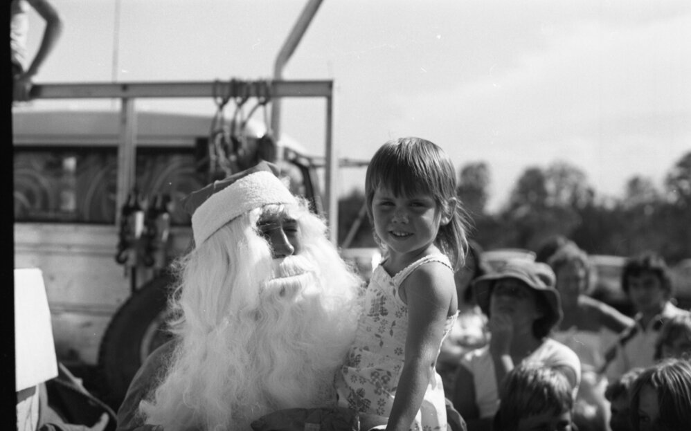 Santa giving unidentified girl a gift, Ipswich, December 1979