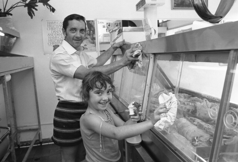 Gary Manning with young assistant behind the counter of Gailes Butchery, Gailes, Ipswich, December 1979