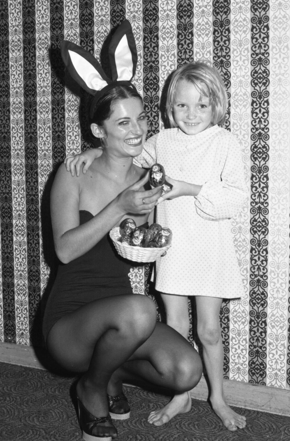 Easter Bunny offering little girl a chocolate Easter Egg, Ipswich, March 1978