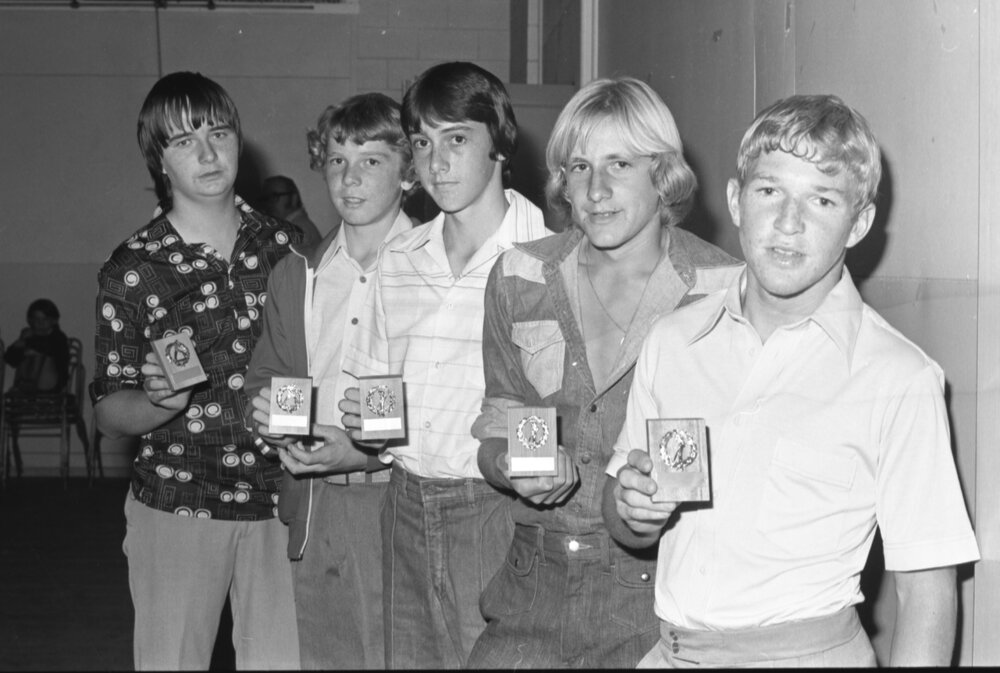 Teenage boys receiving cricket awards with unidentified man, Ipswich, Queensland, April 1978