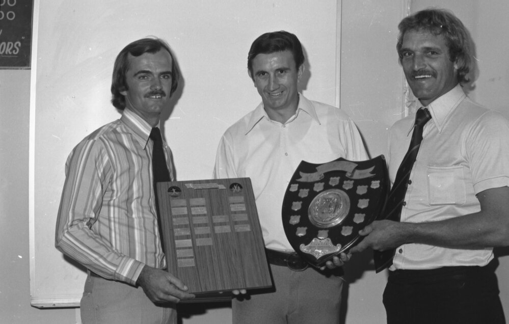 Ray Hine and unidentified men with sports trophies, Ipswich, Queensland, April 1978