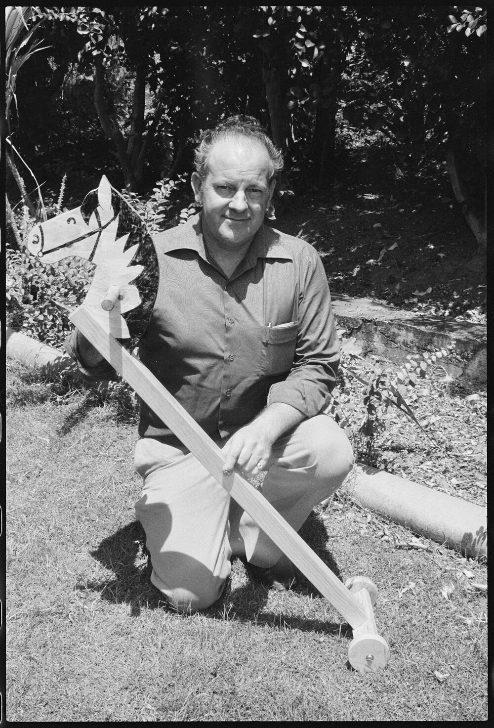 Man holding a toy hobby horse, Ipswich area, January 1986
