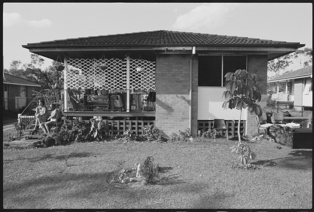 Unidentified couple sitting on the steps outside a house, Ipswich, January 1986