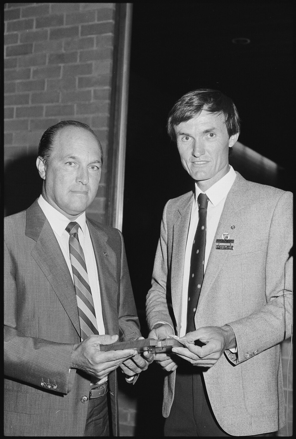 Neil William Russell (right) of Moreton Shire Council presenting an unidentified person a Citizen Award for Australia Day, Ipswich, January 1986 