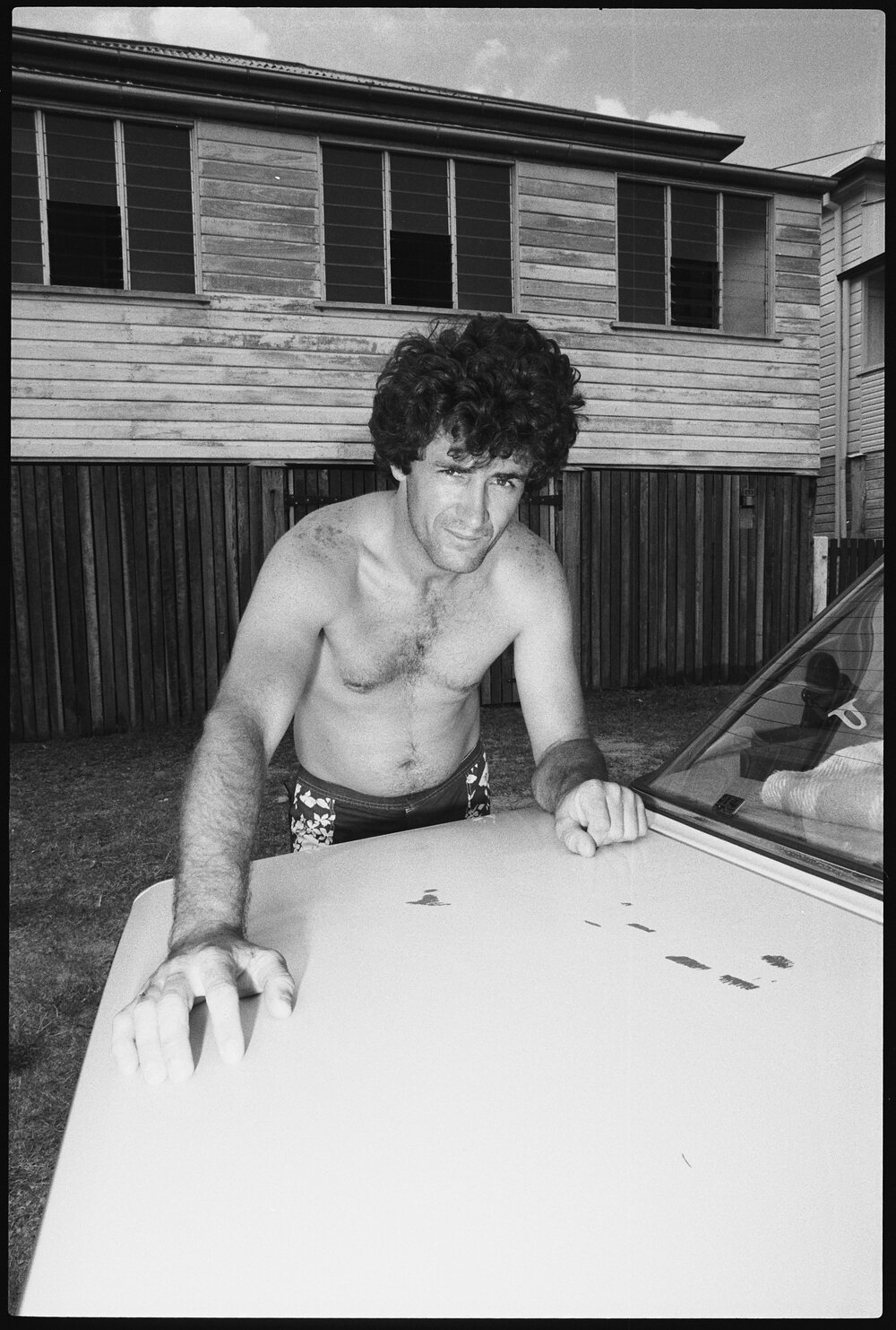 Unidentified man with car in yard, Ipswich, January 1986