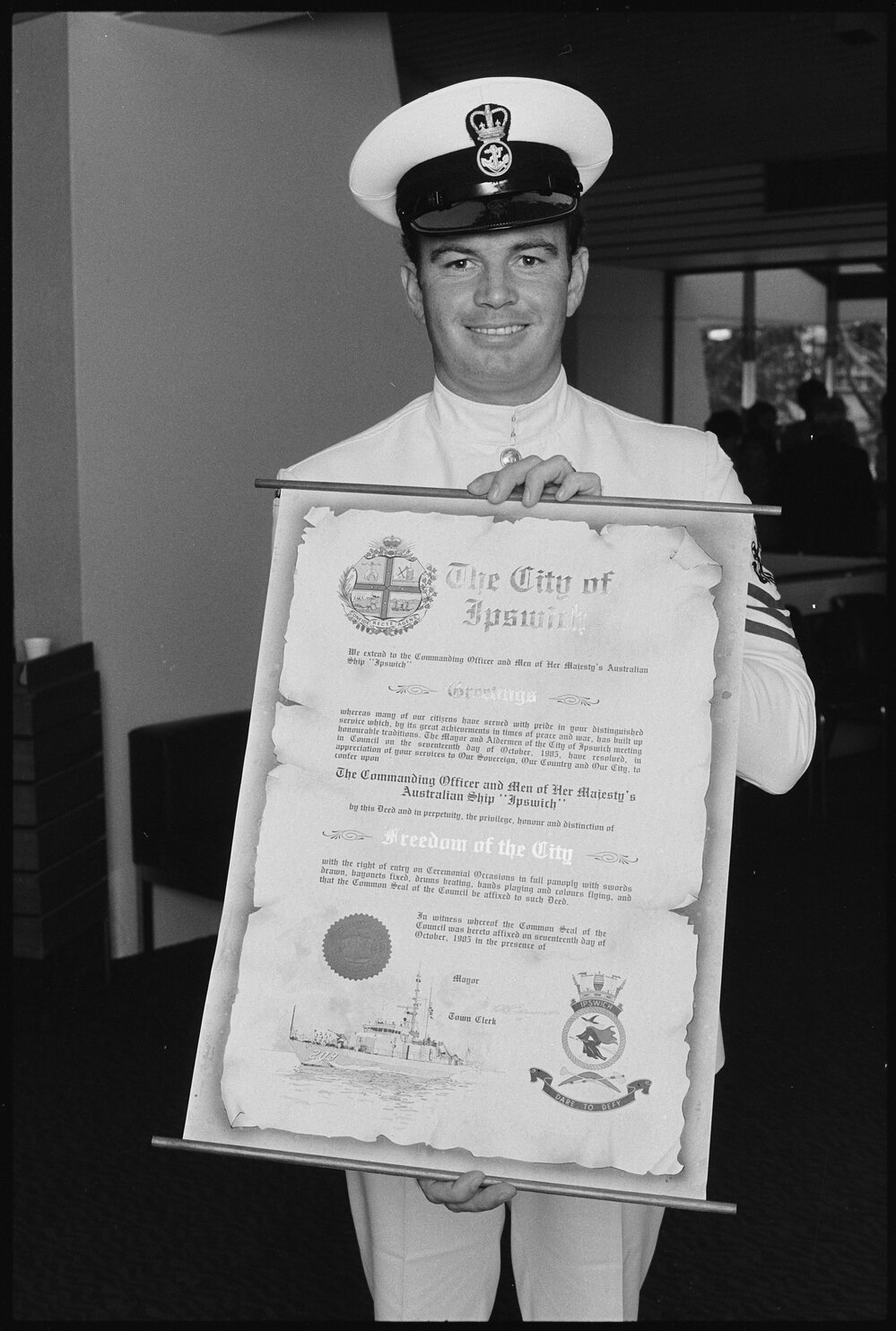 Sailor from the 'HMAS Ipswich' holding the 'Freedom of Entry to the City' deed, Ipswich, January 1986