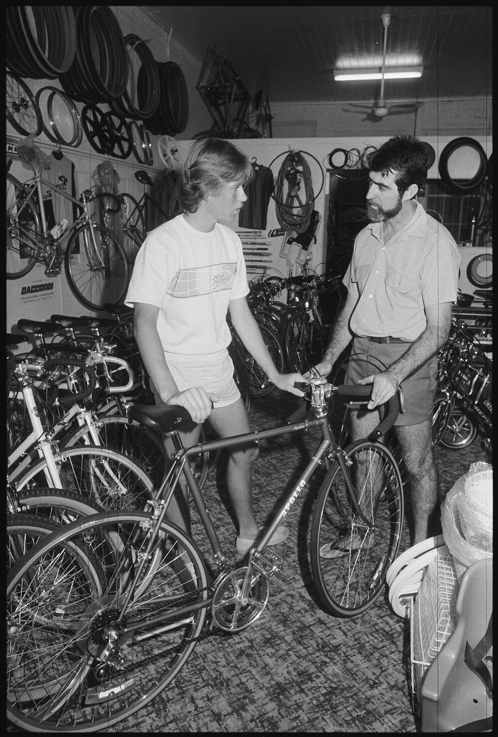 Unidentified sales person selling a bike to a customer, Ipswich, 1986 