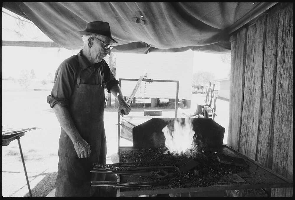 Unidentified man blacksmithing at Laidley Pioneer Village and Museum, Laidley, 1986