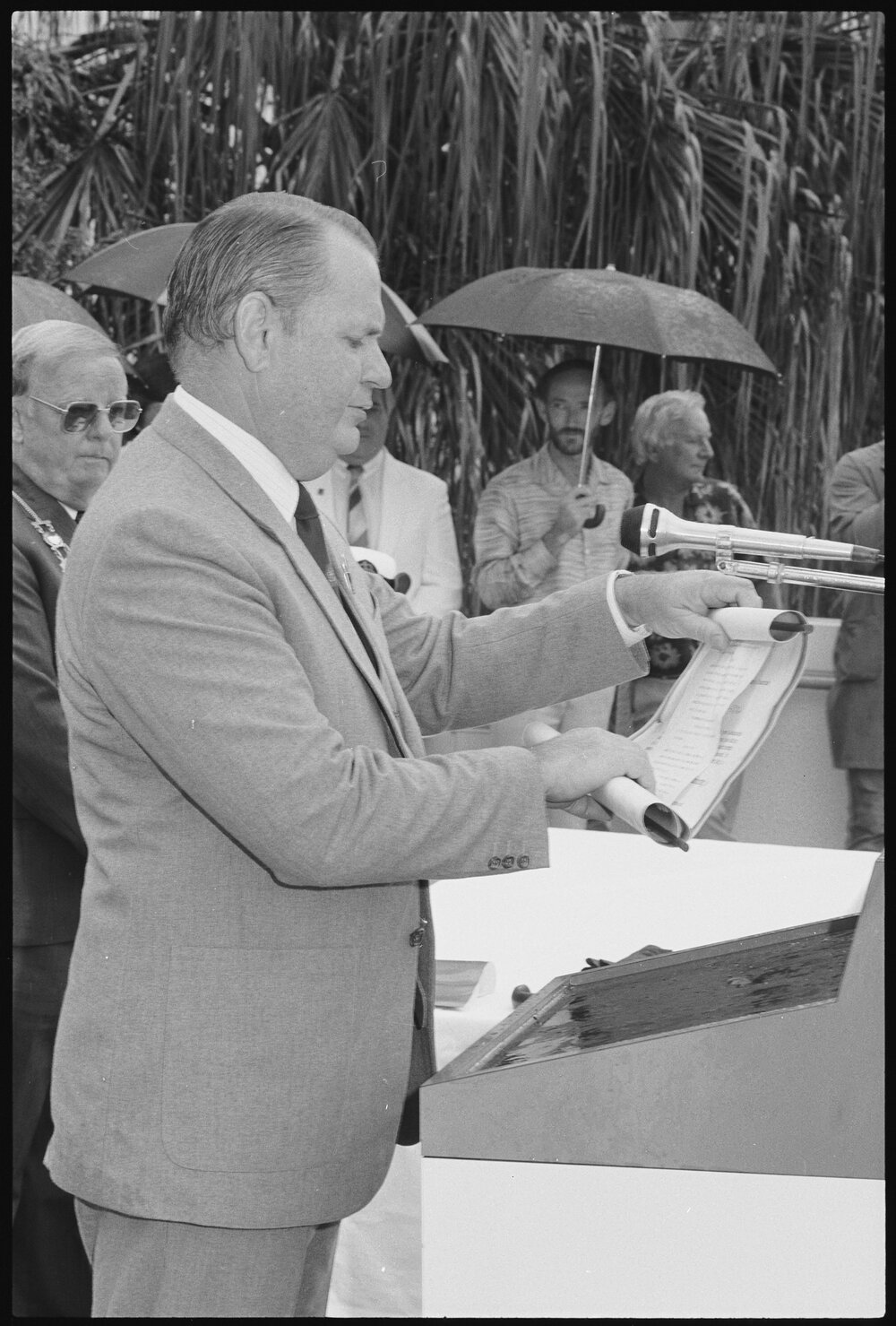 Unidentified man reading the "Freedom of the City" scroll to the crew of H.M.A.S. Ipswich, in front of the Ipswich Civic Centre, January 1986