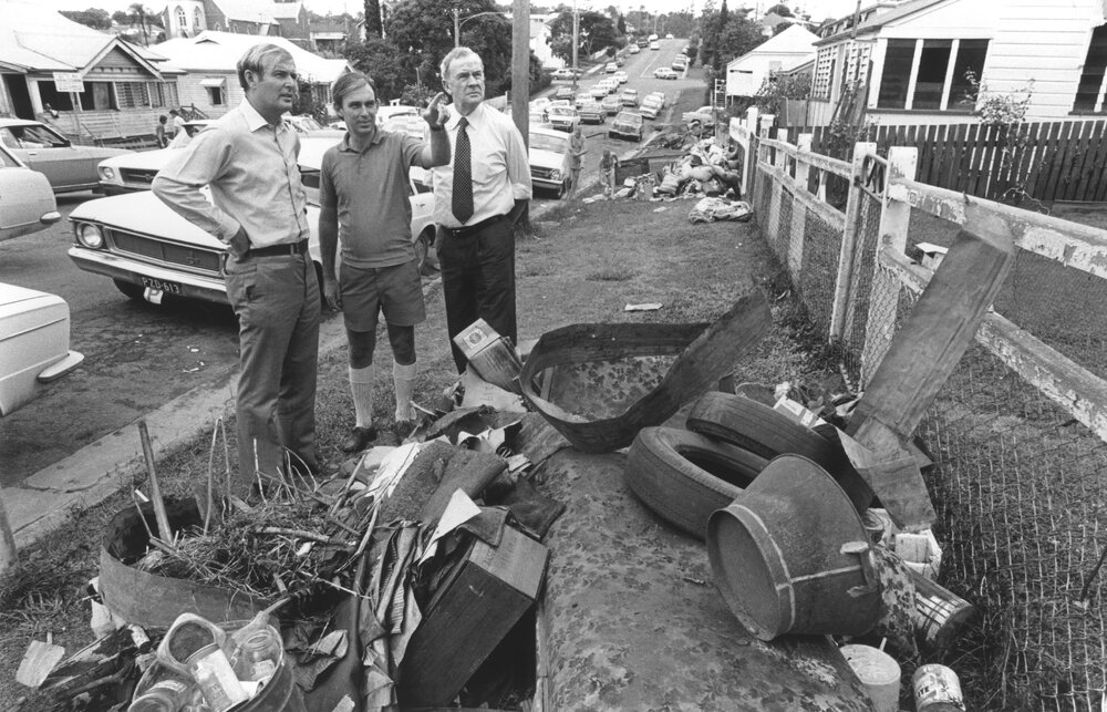 Country Party Leader Doug Anthony, Member for Ipswich Sir Llew Edwards, and State Lands Minister Wally Rae inspecting flood damage in South Street, Ipswich, January 1974