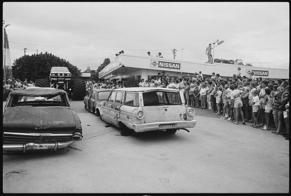 Big-1 Monster Truck running over cars for exhibition at Ipswich Nissan car dealership, Booval, Ipswich, January 1986