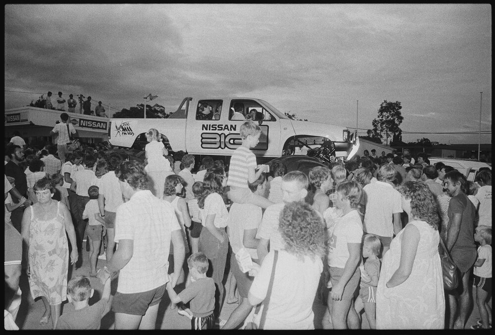 Crowds viewing the Big-1 Monster Truck for exhibition at Ipswich Nissan car dealership, Booval, Ipswich, January 1986