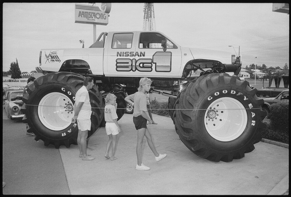 People gathering around the Big-1 Monster Truck for exhibition at Ipswich Nissan car dealership, Booval, Ipswich, January 1986