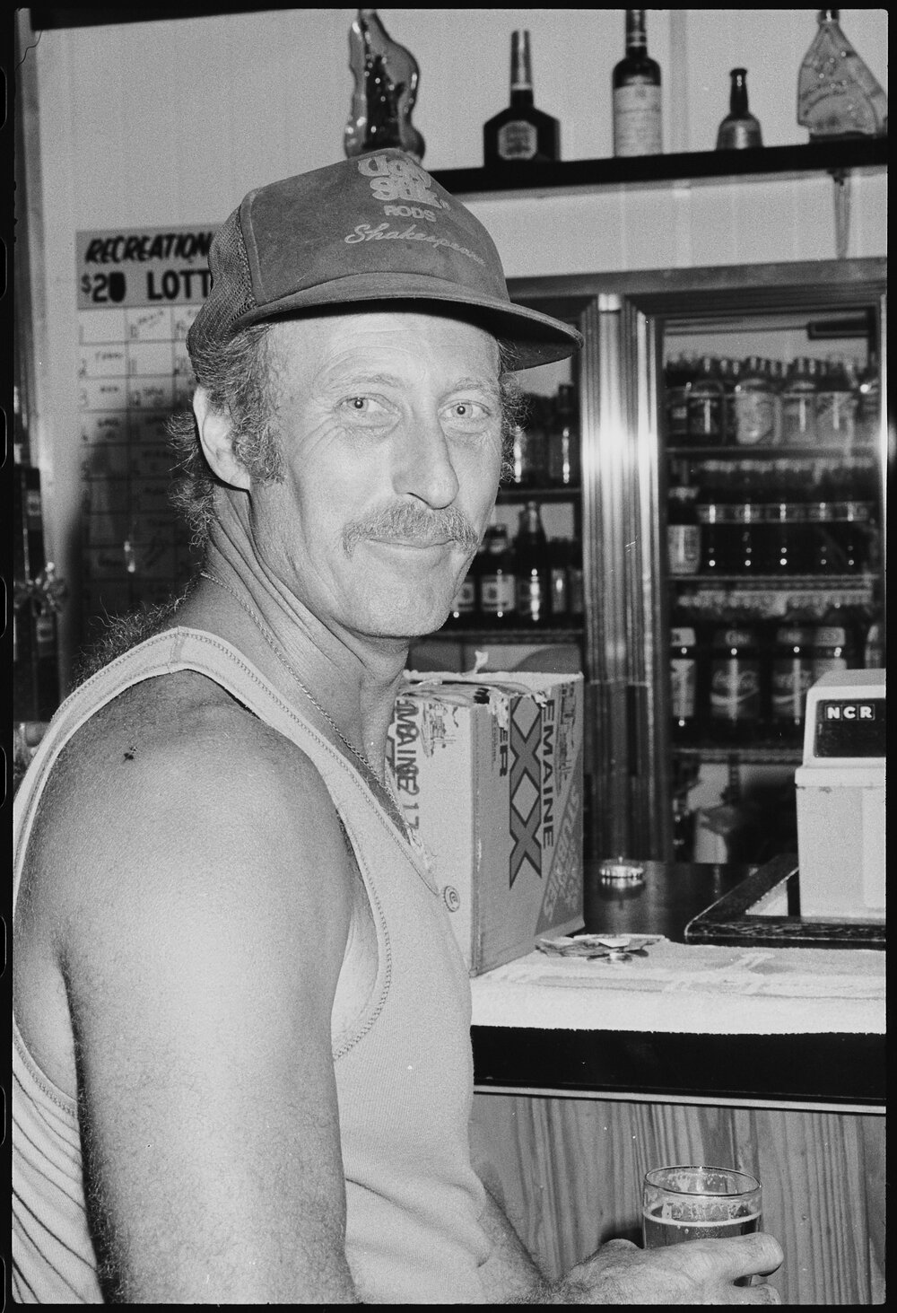 Unidentified man holding a beer at a bar, Ipswich, January 1986
