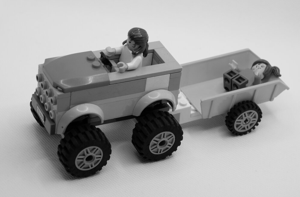 Brickswich version of Horn children in a pedal car with trailer, at Bergin's Hill, Bundamba, from the 1940s