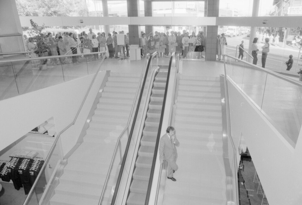 Staff on stairs at opening of McDonnell &amp; East, corner Brisbane and Ellenborough Streets, Ipswich, 1987