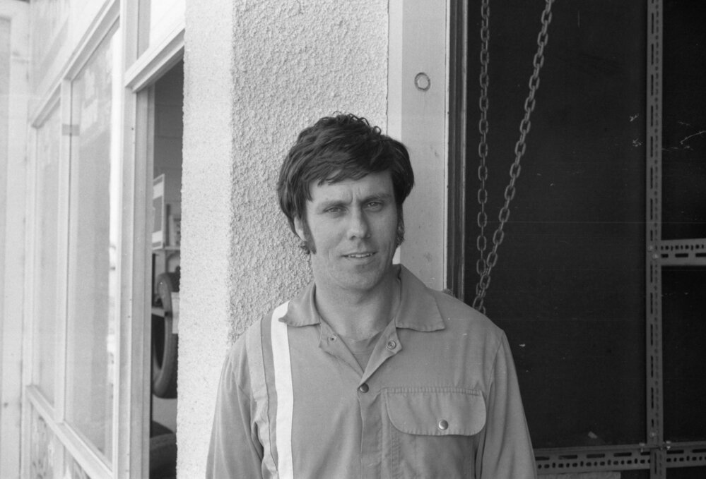 Employee of Jeff Denman's Tyre &amp; Auto Service in coveralls, Ipswich, August 1980