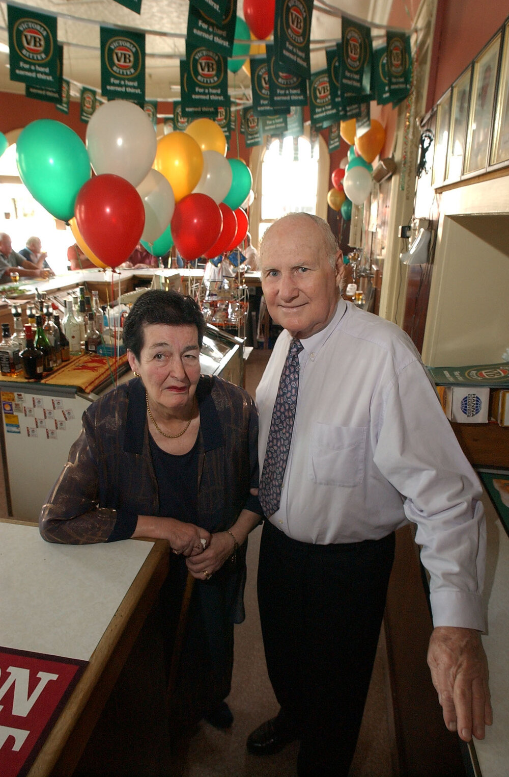 Maisie O'Dempsey and Denis Flannery, and unidentified customers at the Ulster Hotel, Ipswich, December 2003