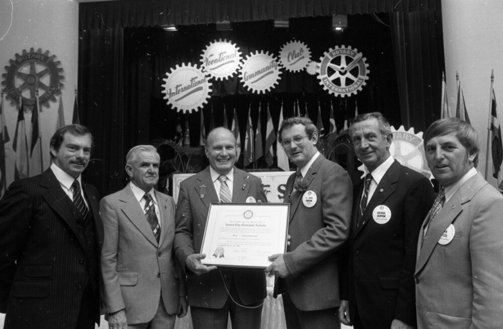 Unidentified men stand with John Dobson, George Skippen, and John Beitzel, thought to be at the Charter Night Celebration for the formation of Goodna Rotary Club, Ipswich, August 1980