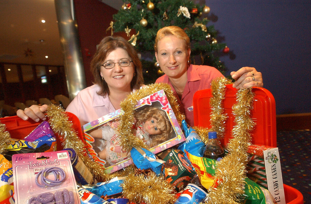 Robina Jones and Sharon Janssen with Christmas presents at Christmas event, Ipswich, December 2003