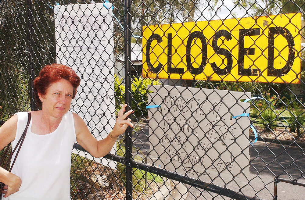 Unidentified woman at Department of Transport closed sign, Ipswich, December 2003