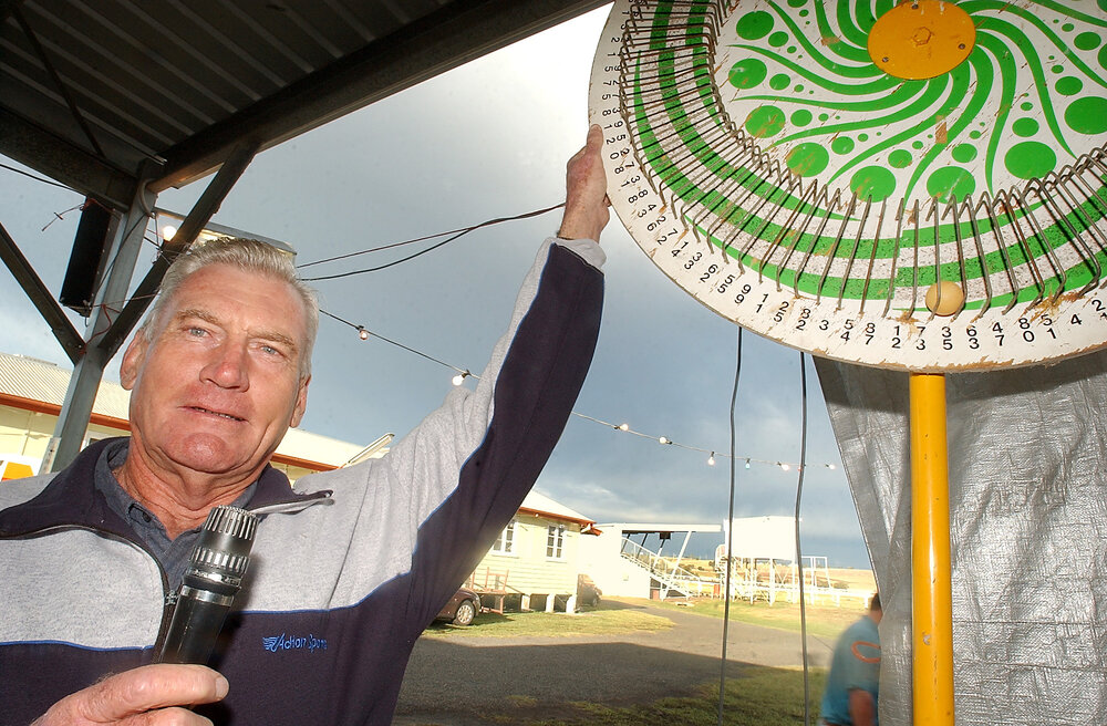 Ken Farquharson spins the ham wheel during the Christmas Carnival at Marburg, Marburg, December 2003