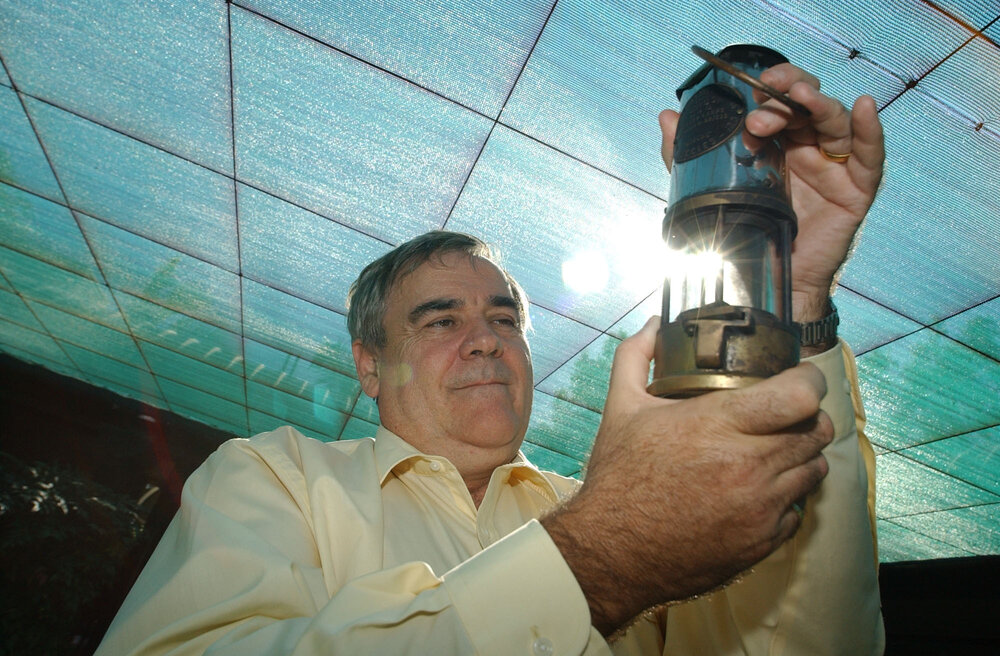 Stewart Bell (director) holding a miner's safety lamp, Ipswich, September 2003