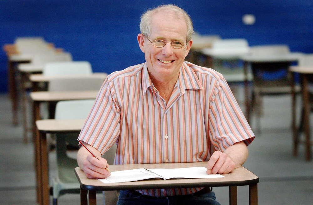 Charles Costello (teacher) sitting in a classroom, Ipswich, September 2003