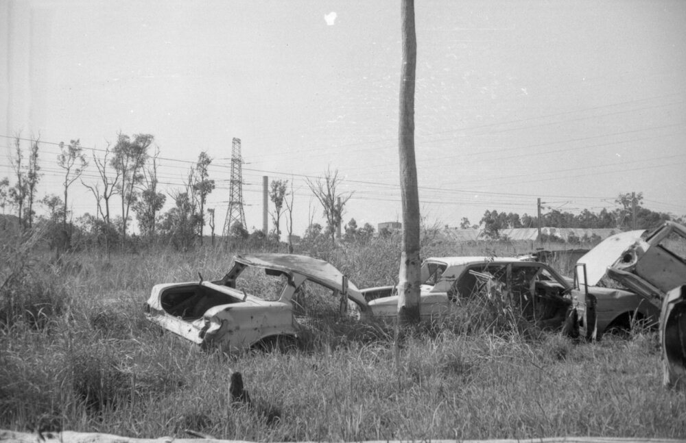 Rusted out cars on a country road, Ipswich, September 1980