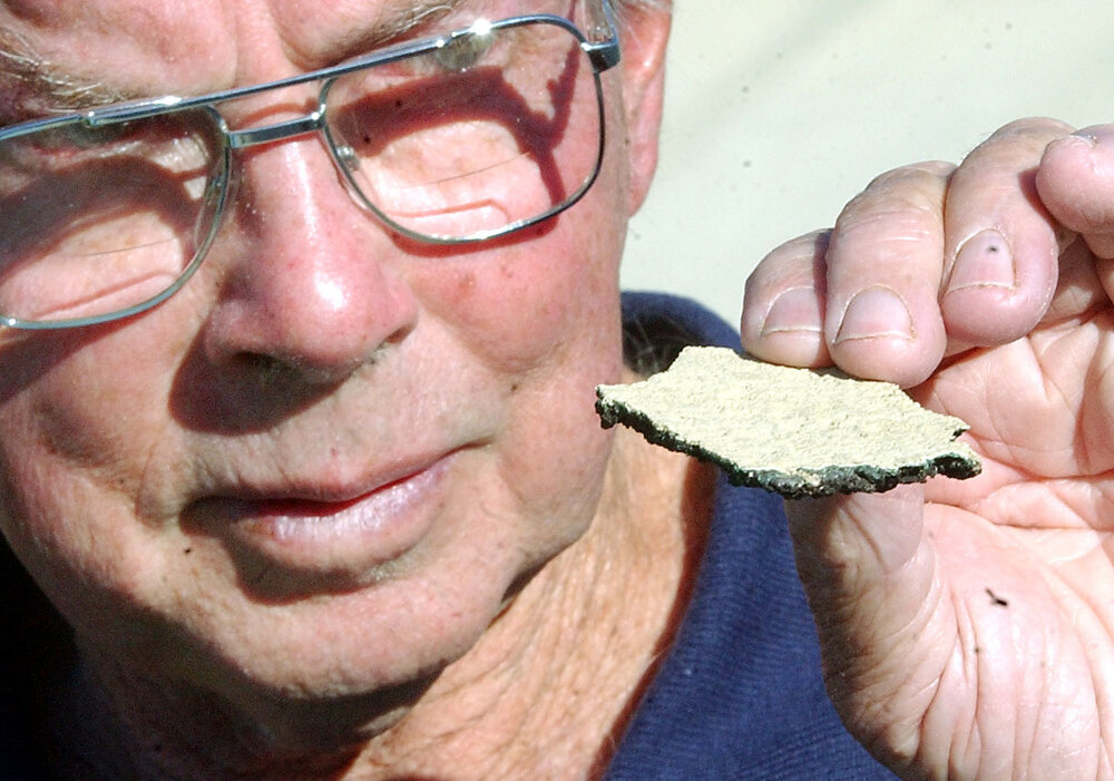 Unidentified man holding a piece of stone, Ipswich, September 2003