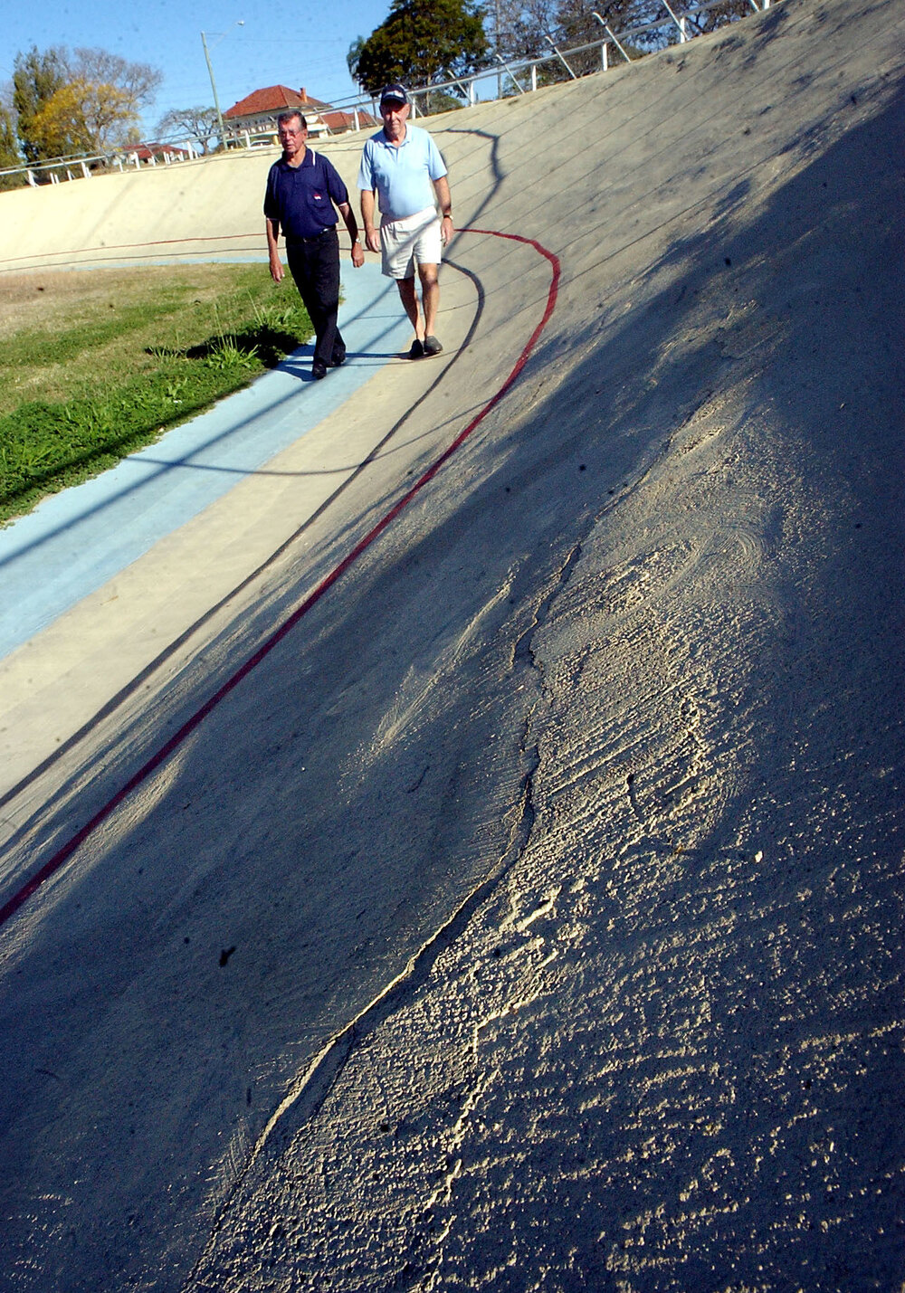 Two unidentified men walking along track in velodrome, Ipswich, September 2003