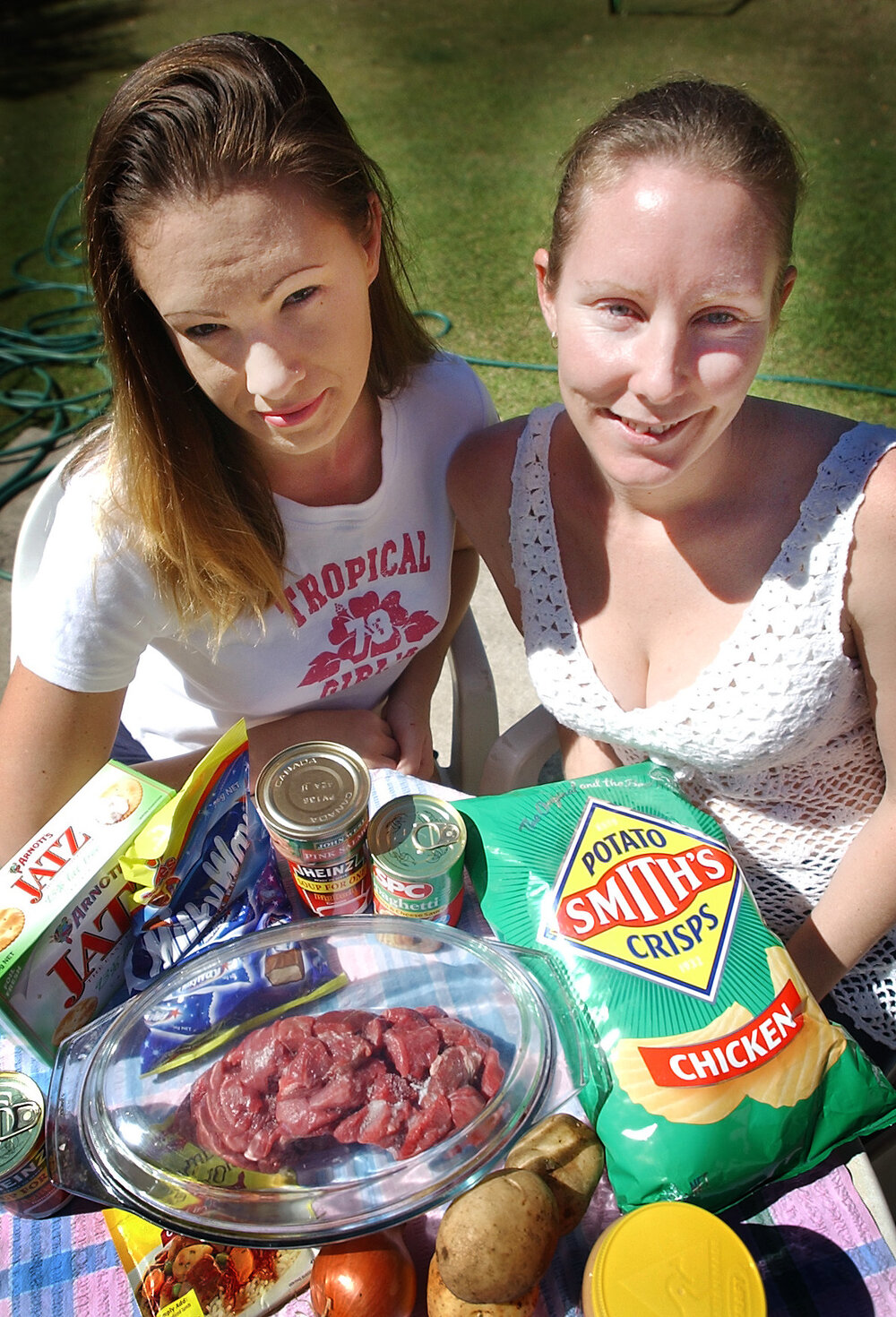 Melinda Lobwein and Laura Carr holding different foods, Ipswich, September 2003