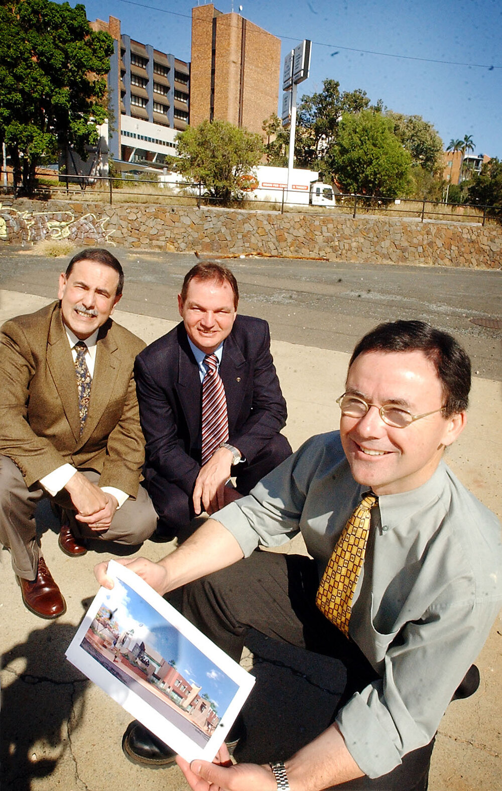 Paul Pisasale, former Mayor and other unidentified men, looking at some architecture plans for the new Day Surgery Hospital, Ipswich, September 2003