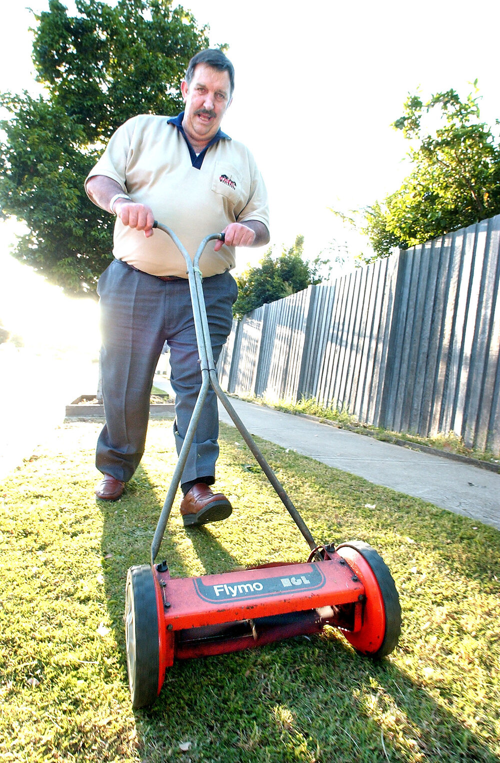 Ed Holmes pushing a lawnmower, Ipswich, September 2003
